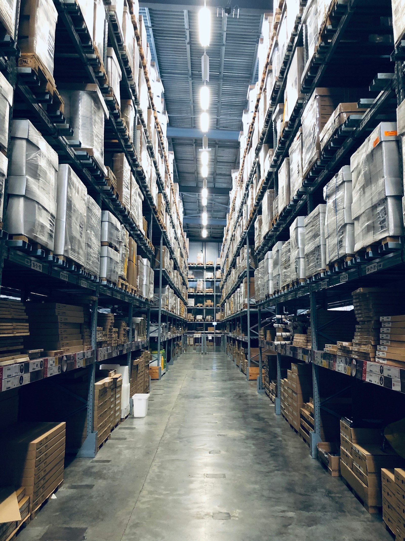 A delivery vehicle loading inside a clean distribution warehouse.